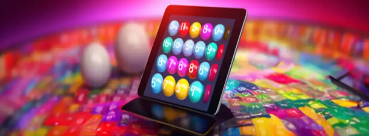 A tablet displaying a colorful bingo card with numbers stands on a vibrant surface