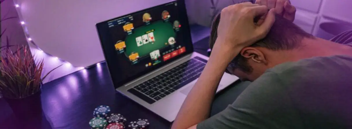 Young man play online poker laptop