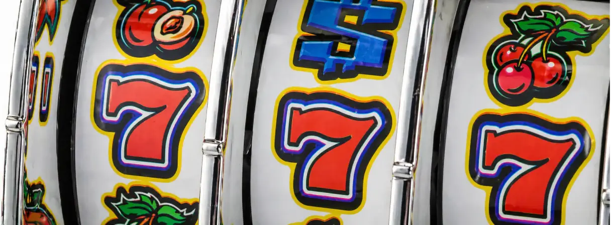Close-up of a slot machine showing spinning reels with symbols